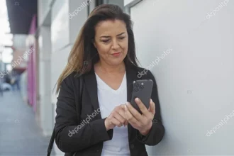 A female entrepreneur handling business on the go using smartphone apps