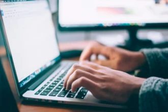 A person sitting at a desk viewed from above.