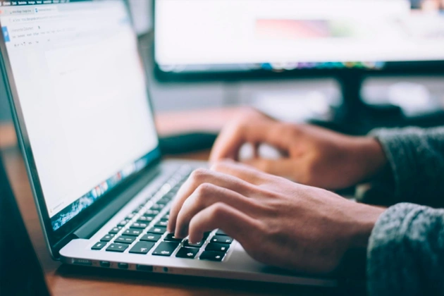 A person sitting at a desk viewed from above.