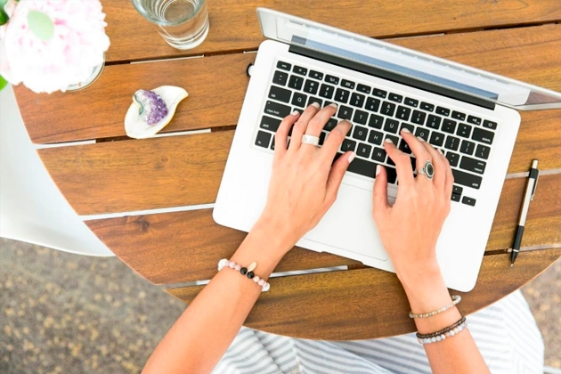 A person using their laptop. A person using their laptop.