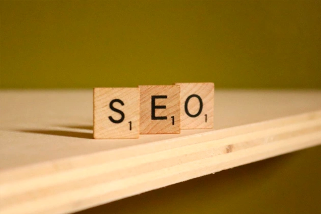 Three Scrabble letters (SEO) on a wooden board. Three Scrabble letters (SEO) on a wooden board.