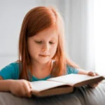 Girl in Blue T shirt Reading Book