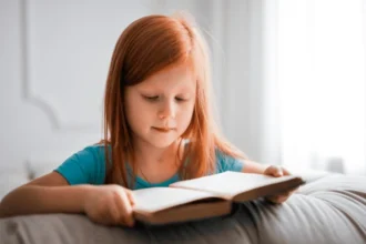 Girl in Blue T shirt Reading Book